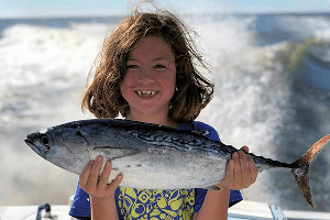 Check the great smile on this kid with a false albacore tuna on an Outer Banks Fishing Charter.
