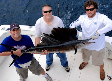 Two anglers with Outer Banks sailfish release on offshore fishing charter.