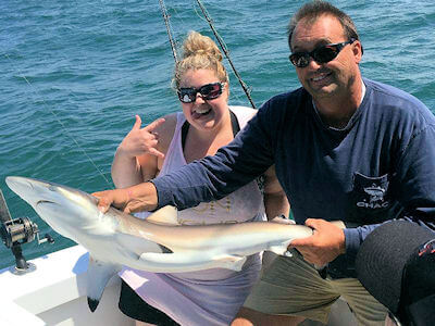 Outer Banks angler holds shark.