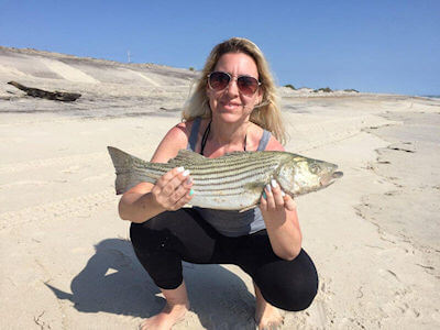Lady with striped bass.